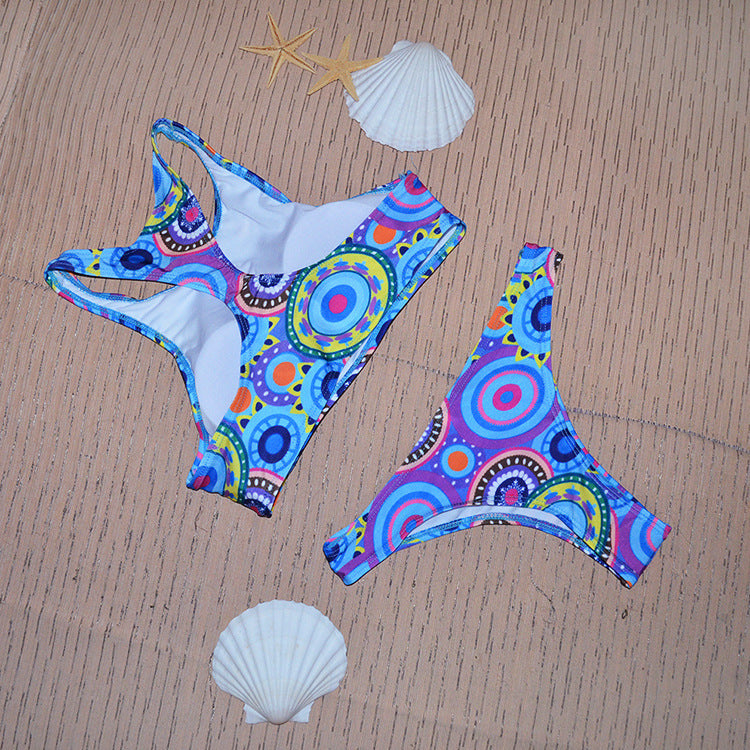 Colorful bikini set with starfish and shells on a brown textured background