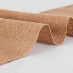 Rolled-up burlap fabric on a light gray background